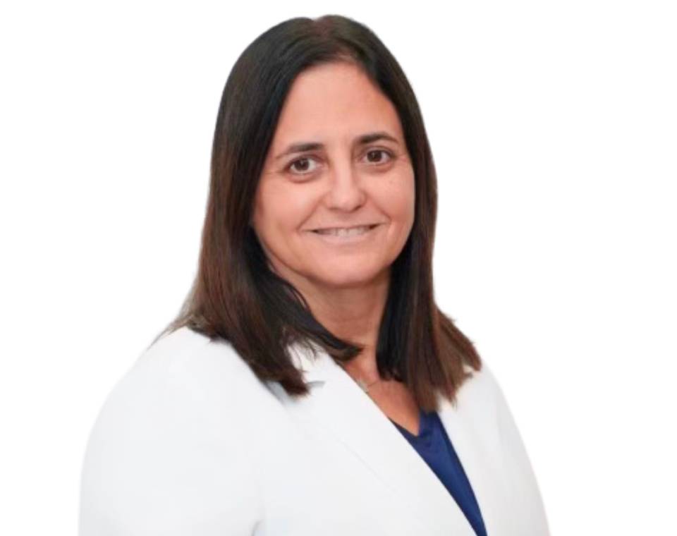 Smiling woman with long dark hair wearing a white blazer.